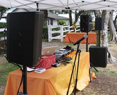 iPlay sound system tent booth display setup with microphones, speakers, subwoofers, laptop and mixer.