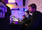 AV tech support personnel work at table with computer monitors and headsets at JW Marriott Los Angeles LA Live Fundraiser.