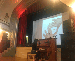Woman playing piano in front of audience
