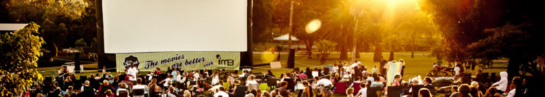 a large outdoor movie event at sunset.